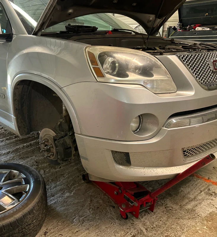 Vehicle with its wheel removed during workshop repair